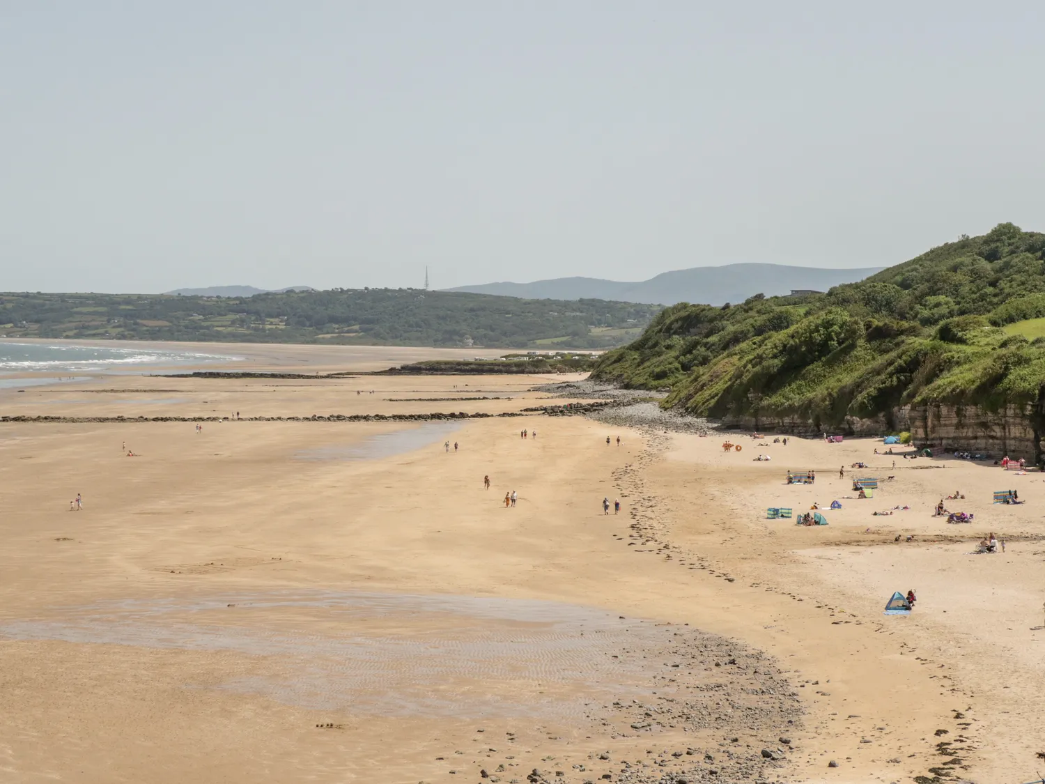 Families and couples on the beach at Benllech in summer on the Isle of Anglesey.