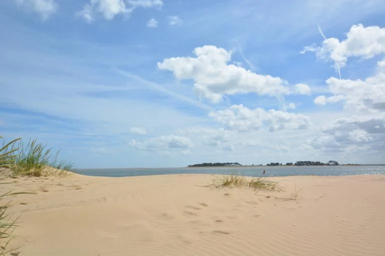 The empty sandy beach at Wells-next-the-Sea in Norfolk on a sunny cloudy day.