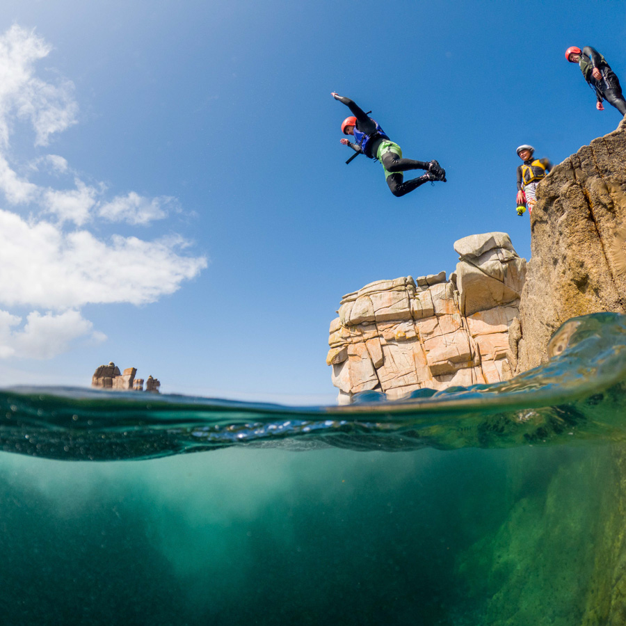 Jumping in the sea whilst coasteering in Cornwall