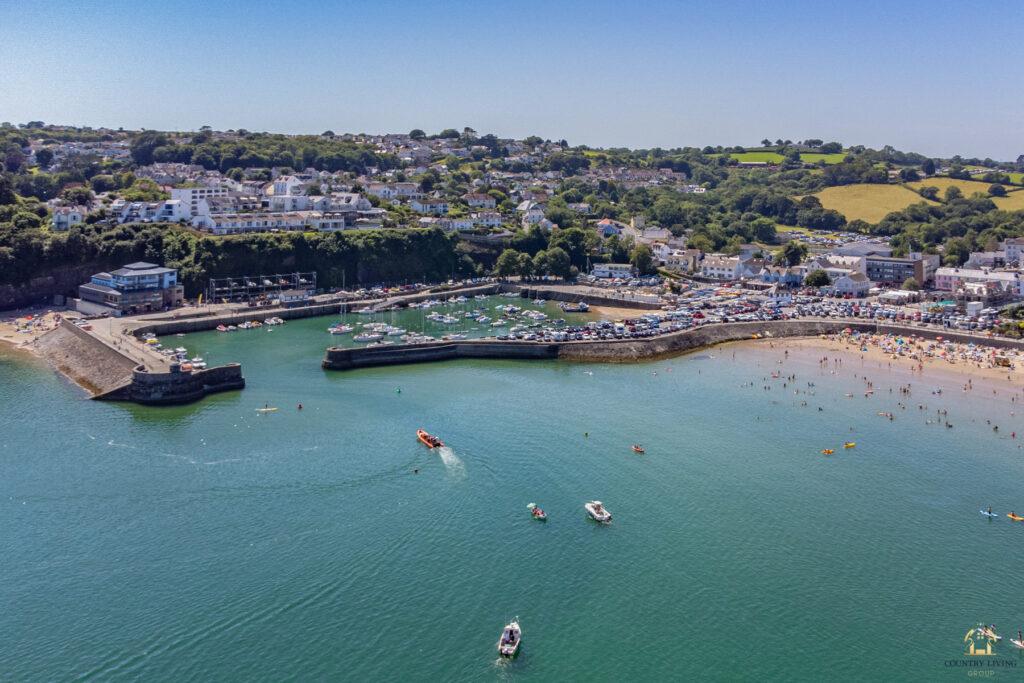 Aerial view of boat arriving at Saundersfoot harbour on a sunny day