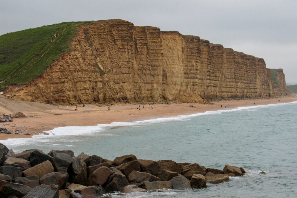 Towering cliffs behind West Bay beach in Dorset