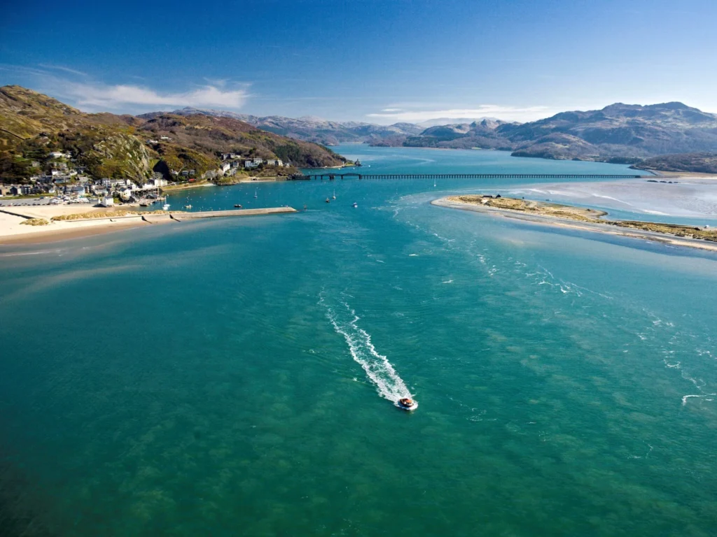 Boat leaving the harbour at Aberdovey on a sunny day