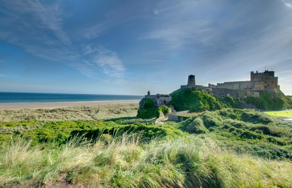 Majestic Bamburgh Castle in the sand dunes with sea views