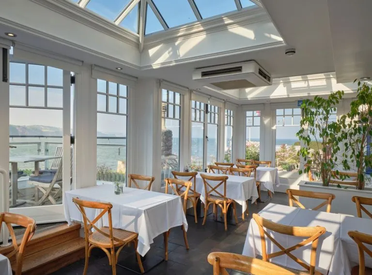Light filled restaurant the Cary Arms overlooking Babbacombe beach in Torquay