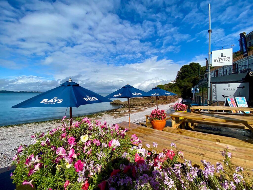 Outdoor terrace with sea views at Breakwater Bistro in Devon