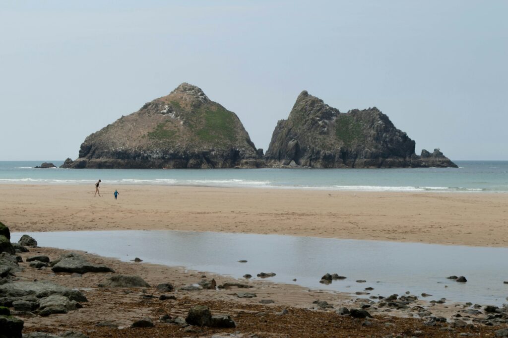 Two children playing on Holywell Beach, Cornwall