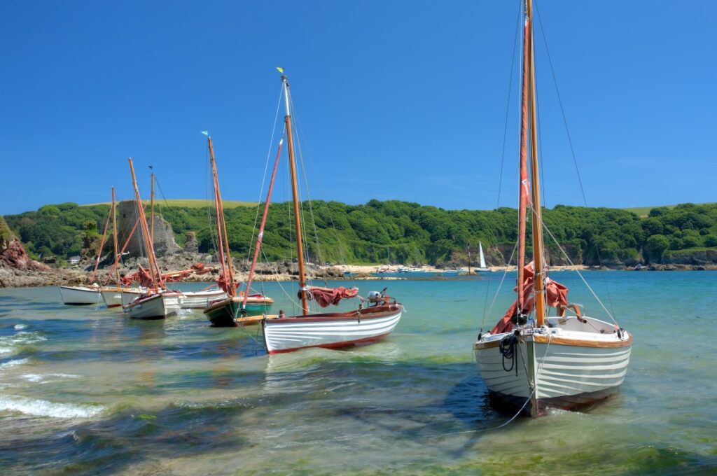 Sailing boats moored on the beach at Salcombe, Devon