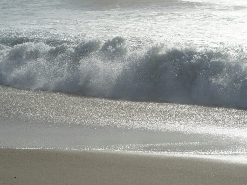 Waves crashing on the sand in Cornwall
