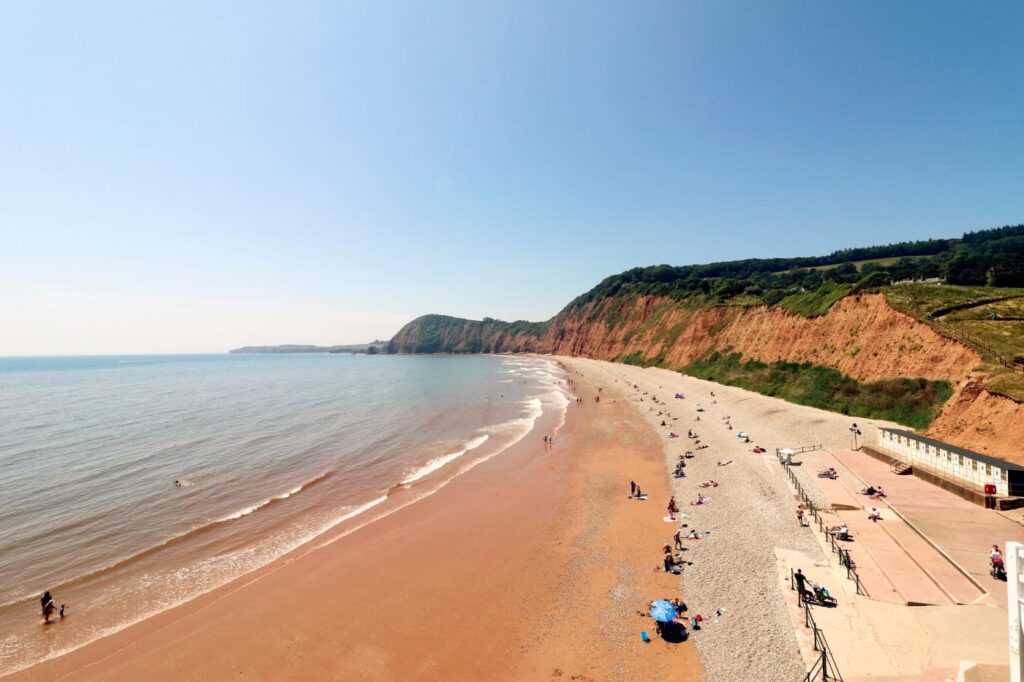 Looking along Sidmouth beach backed by red cliffs
