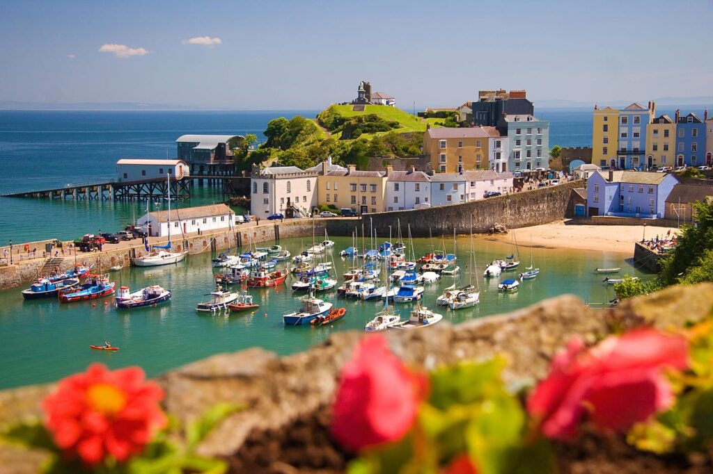 Tenby's colourful harbour full of boats on a sunny day